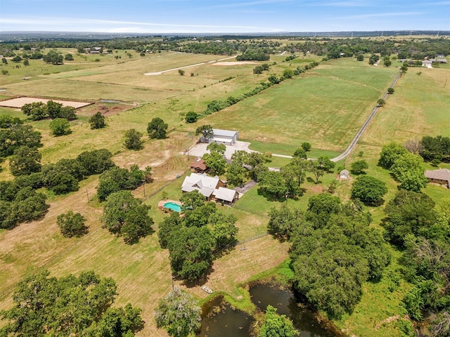 birds eye view of property with a rural view