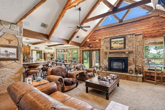 carpeted living room featuring a fireplace, ceiling fan, plenty of natural light, and high vaulted ceiling