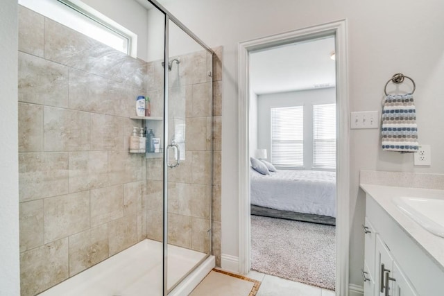 bathroom featuring tile patterned floors, plenty of natural light, an enclosed shower, and vanity