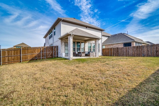 back of house featuring a yard and a patio