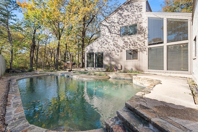 view of pool with a hot tub and a patio