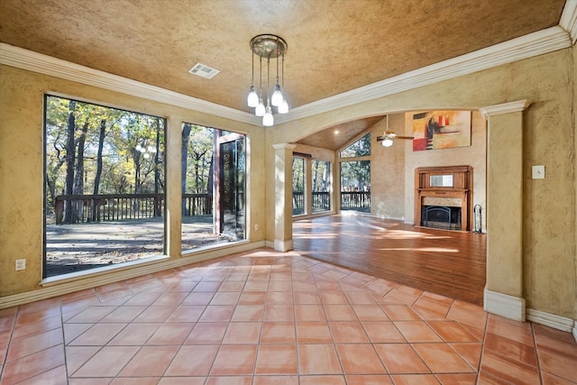 interior space with tile patterned flooring, a notable chandelier, and crown molding