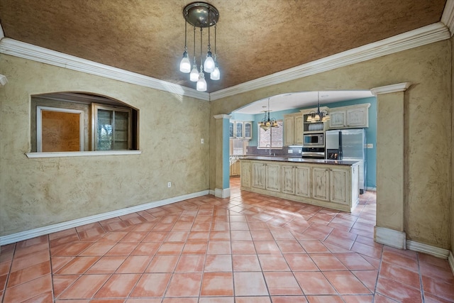 kitchen featuring decorative light fixtures, a notable chandelier, light brown cabinets, stainless steel appliances, and decorative columns