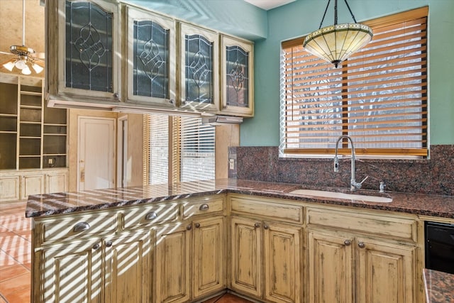 kitchen with plenty of natural light, tasteful backsplash, hanging light fixtures, and sink