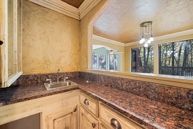 kitchen featuring decorative light fixtures, sink, light brown cabinets, ornamental molding, and ceiling fan with notable chandelier