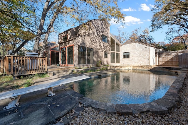 back of house with a swimming pool side deck