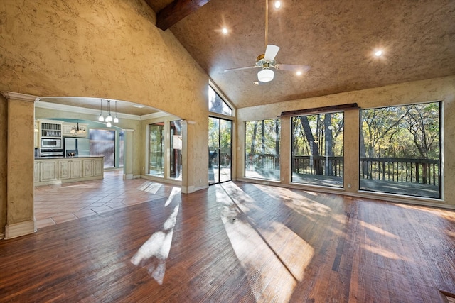 interior space with high vaulted ceiling, beam ceiling, ceiling fan, and a healthy amount of sunlight