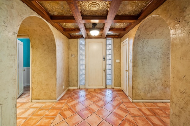 tiled foyer with beam ceiling, coffered ceiling, and ornamental molding