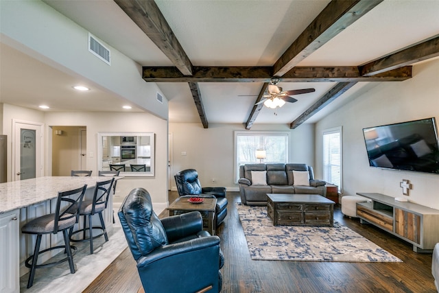 living room with ceiling fan, beamed ceiling, and dark hardwood / wood-style floors