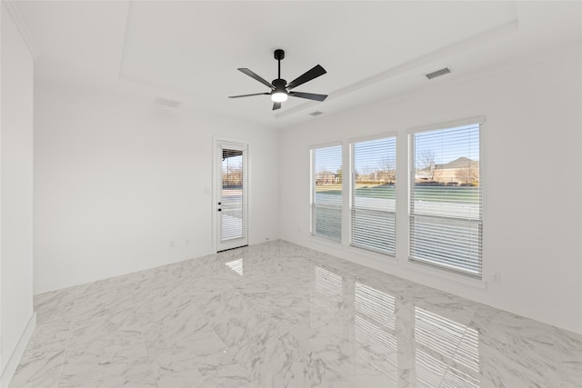 unfurnished room featuring ceiling fan and a tray ceiling