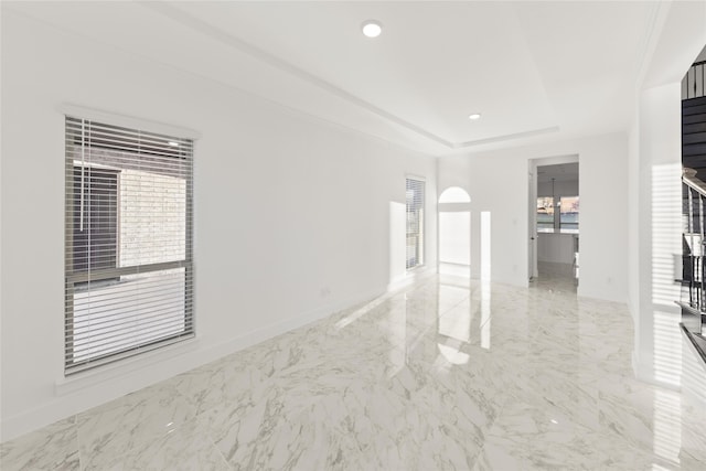 spare room featuring a tray ceiling