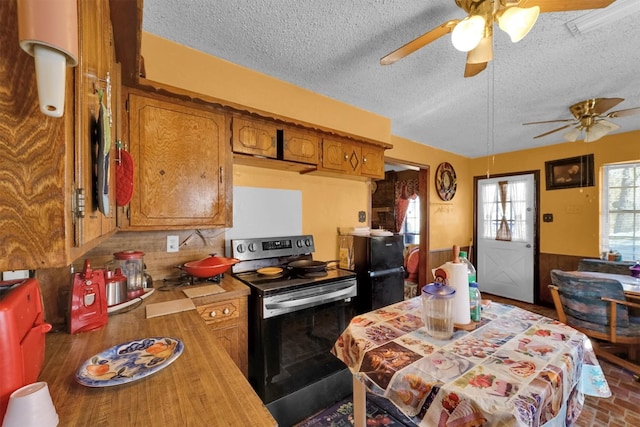 kitchen featuring ceiling fan, black electric range oven, and a textured ceiling