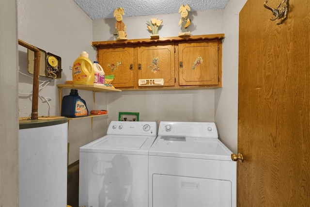 laundry room with cabinets, a textured ceiling, washer and dryer, and water heater