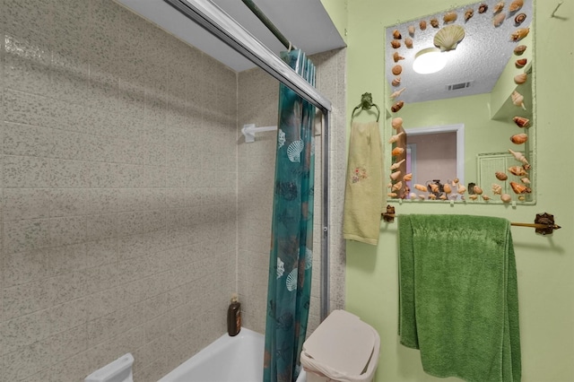 bathroom with toilet and shower / bath combo with shower curtain