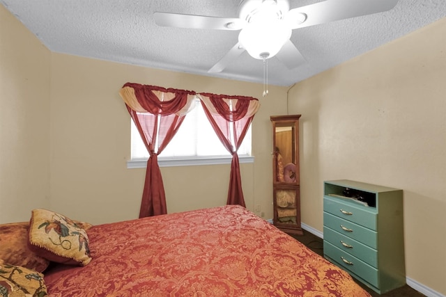 bedroom featuring a textured ceiling and ceiling fan