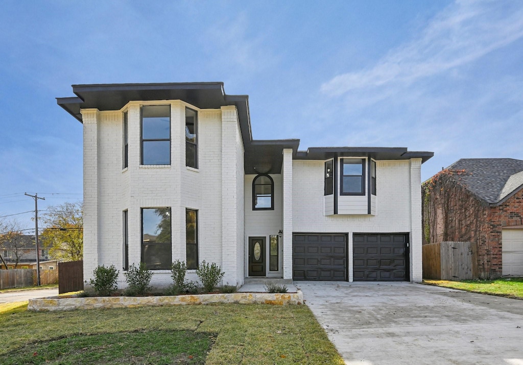 view of front facade featuring a front lawn and a garage