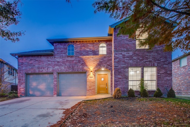 view of front of home featuring concrete driveway and brick siding