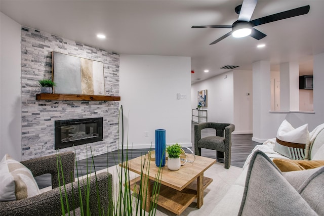 living room featuring recessed lighting, a fireplace, a ceiling fan, baseboards, and visible vents