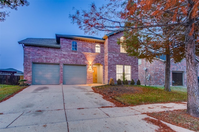 view of front of property featuring driveway, a garage, and brick siding