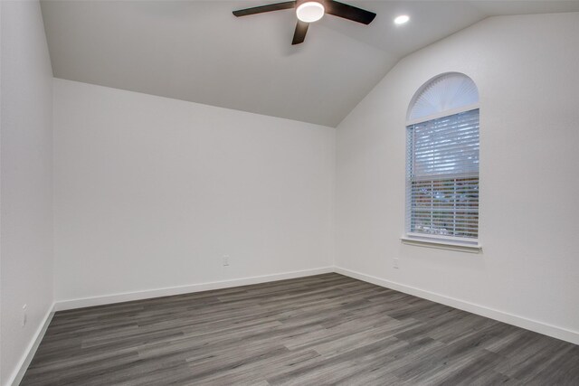 spare room featuring lofted ceiling, ceiling fan, recessed lighting, baseboards, and dark wood-style floors