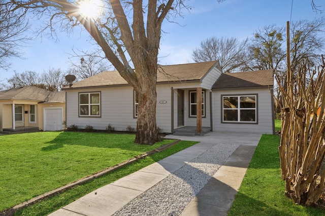 view of front of home with a front yard and an attached garage