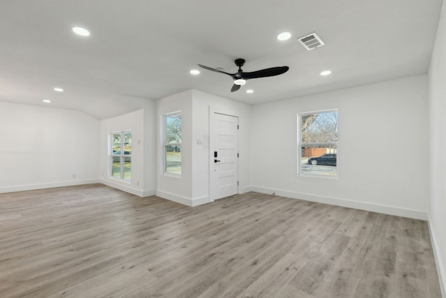 spare room with light wood-type flooring, a healthy amount of sunlight, visible vents, and recessed lighting