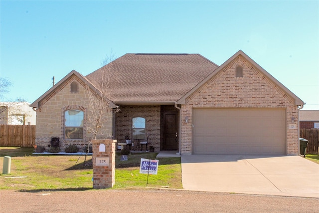 ranch-style home with a garage and a front lawn