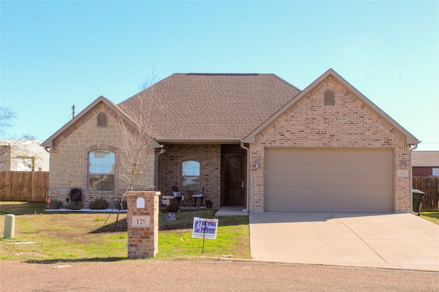 ranch-style home with a garage and a front lawn