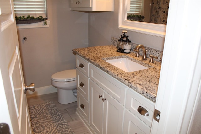 bathroom featuring vanity and toilet