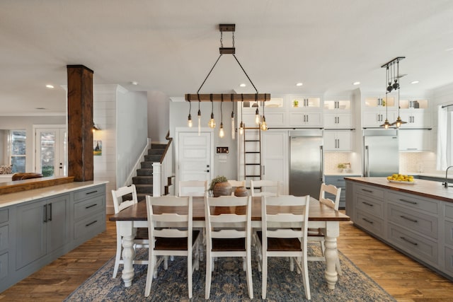 dining room with light wood-type flooring and crown molding