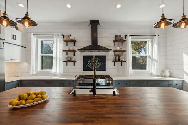 interior space featuring butcher block counters, a wealth of natural light, and island exhaust hood