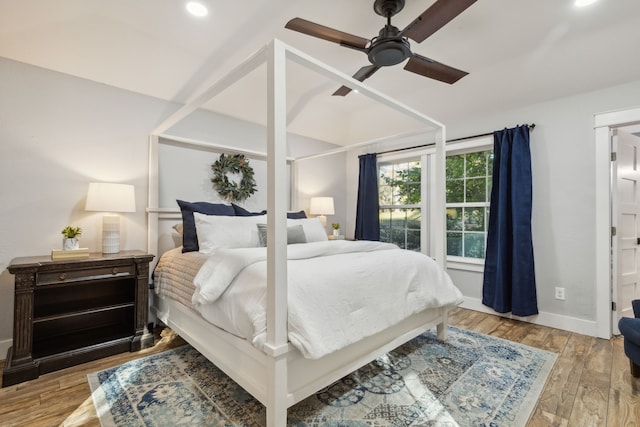 bedroom with ceiling fan and light hardwood / wood-style floors