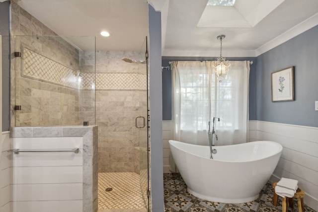 bathroom with a notable chandelier and separate shower and tub