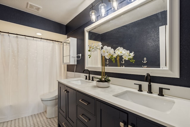 bathroom featuring tile patterned floors, vanity, and toilet