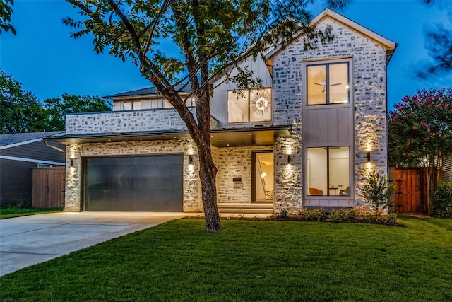 view of front of house with a garage and a front lawn