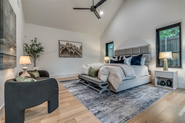 bedroom featuring hardwood / wood-style flooring, high vaulted ceiling, and ceiling fan