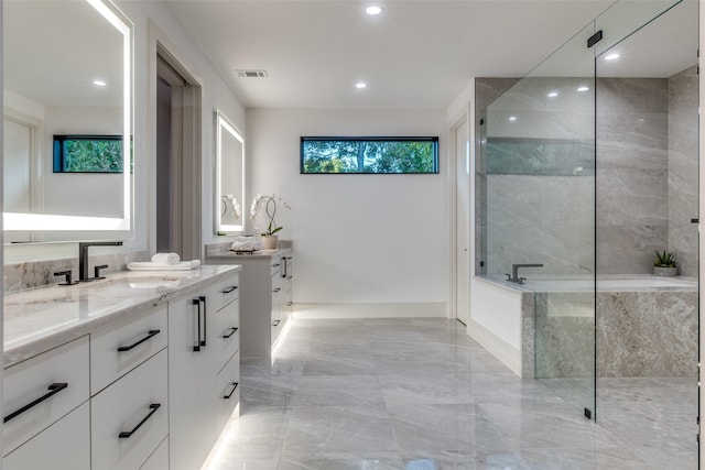 bathroom featuring a tile shower and vanity