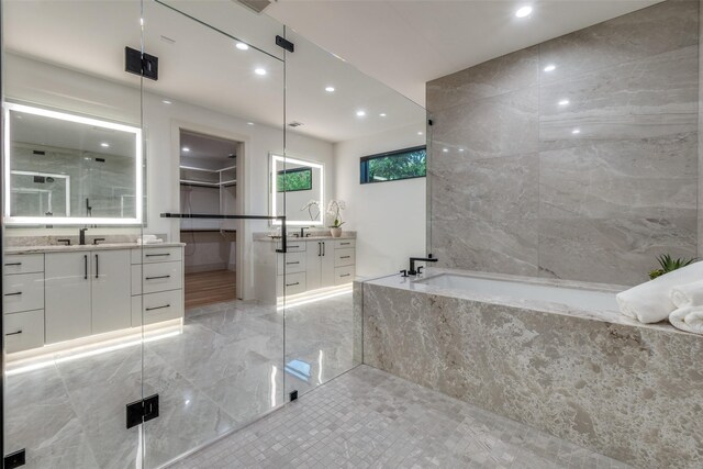 bathroom featuring separate shower and tub and vanity