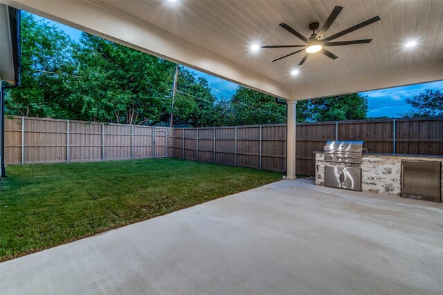 view of patio with area for grilling, a grill, and ceiling fan