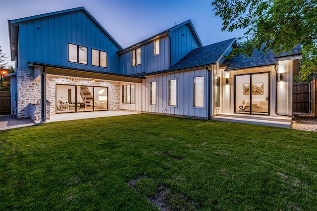 rear view of property with a patio area and a lawn