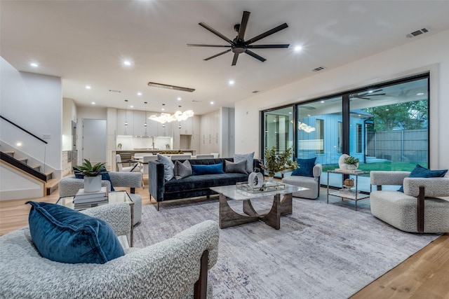 living room with ceiling fan and light hardwood / wood-style floors