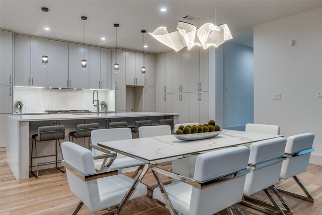 dining space with light hardwood / wood-style flooring