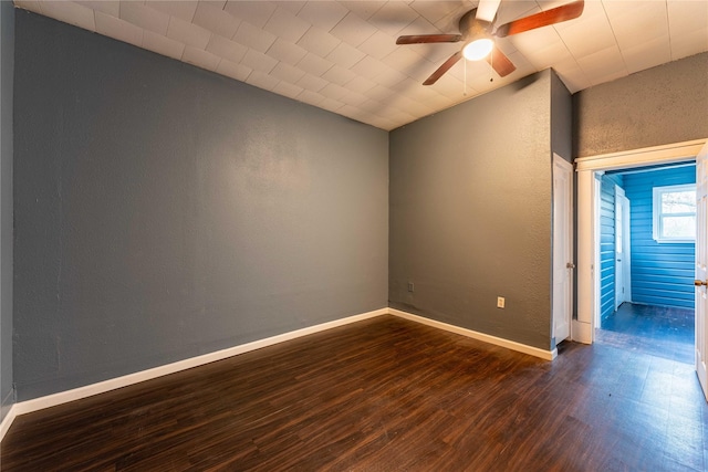 unfurnished room featuring ceiling fan and dark wood-type flooring