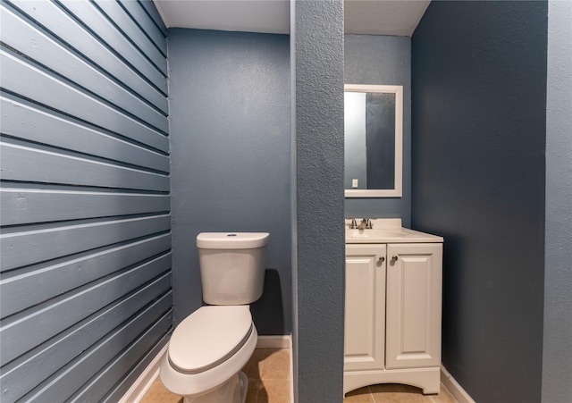 bathroom featuring tile patterned flooring, toilet, and sink