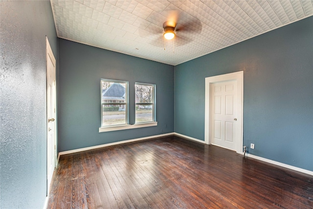 empty room with ceiling fan and dark hardwood / wood-style flooring