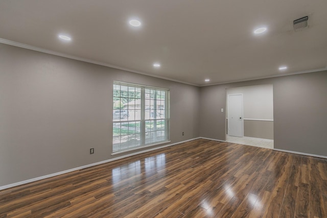 empty room with dark hardwood / wood-style floors and ornamental molding