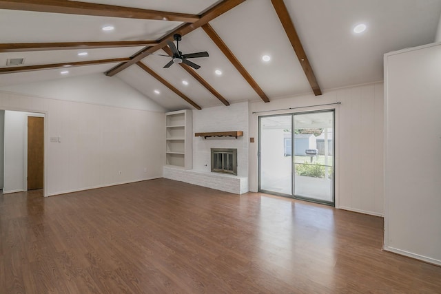 unfurnished living room with lofted ceiling with beams, a brick fireplace, ceiling fan, and dark wood-type flooring