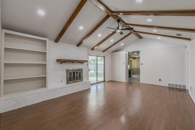 unfurnished living room featuring ceiling fan, dark wood-type flooring, lofted ceiling with beams, and a brick fireplace