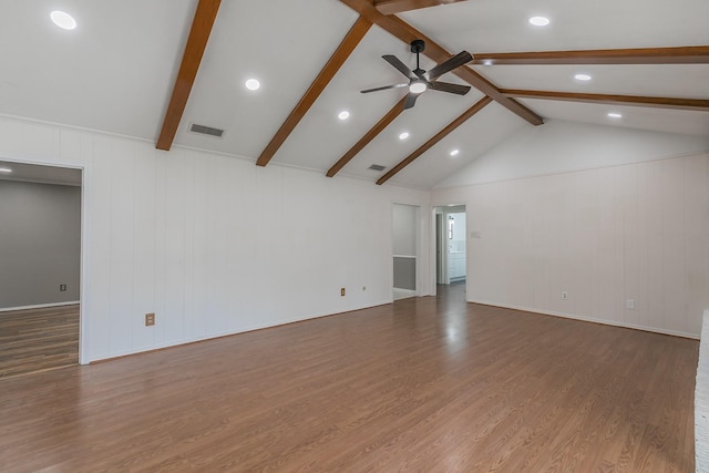 unfurnished living room with hardwood / wood-style floors, vaulted ceiling with beams, and ceiling fan