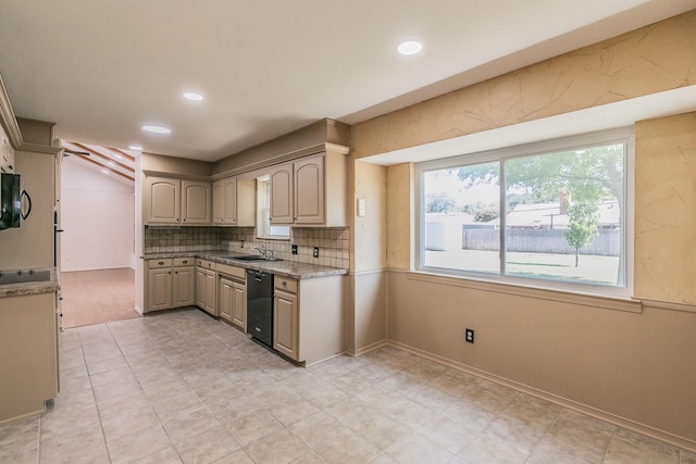 kitchen featuring black appliances, decorative backsplash, light stone countertops, and sink